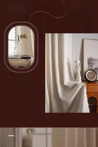 Detail of cream jacquard curtain fabric with decorative tassels in a French retro style