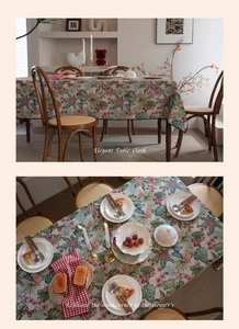 Detailed texture of jacquard tablecloth with pink flowers and tropical palm leaf patterns