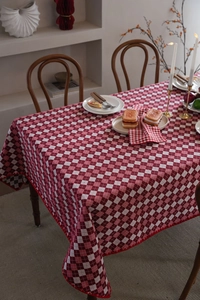 Macro shot of red checkered jacquard tablecloth with elegant scalloped wave edge detail