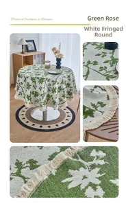Detail of green rose floral pattern jacquard fabric with white fringe edge on round tablecloth