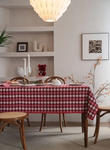 Detail of red and white lattice jacquard tablecloth with festive scalloped wave edges