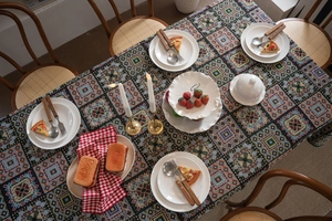 Detailed close-up of bohemian woven tablecloth with vibrant colorful geometric patterns