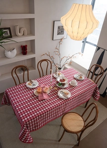 Detail view of red and white checkered tablecloth featuring jacquard floral embroidery