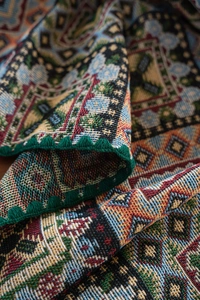 Close-up of bohemian geometric jacquard tablecloth with detailed crochet edges
