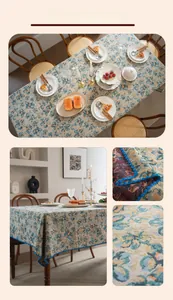 Detail view of jacquard tablecloth with vintage blue floral patterns and shell-shaped lace edges