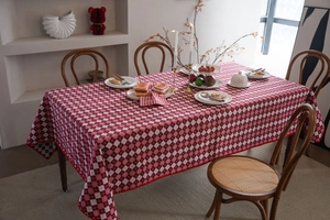 Detailed close-up of a red and white checkered tablecloth with high-quality hemmed edges