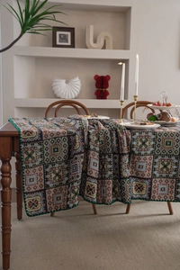 Close-up of French vintage geometric jacquard tablecloth with ethnic embroidery details