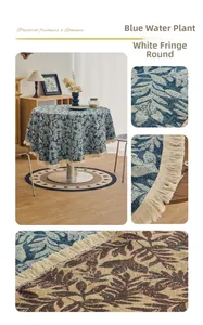 Detail of round blue seaweed jacquard tablecloth with elegant white fringe tassels
