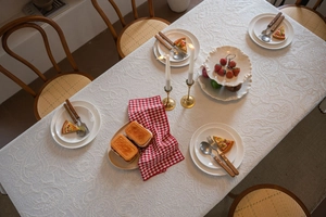 Macro view of white embossed jacquard tablecloth with French luxury floral texture patterns