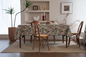 Detail of bohemian jacquard tablecloth with pink flowers and green leaf patterns