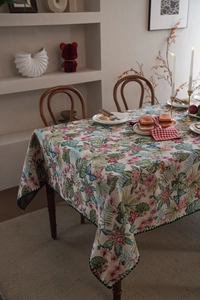 Detailed macro view of woven jacquard tablecloth with pastoral floral and leaf patterns