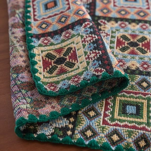 French vintage checkered jacquard tablecloth with geometric patterns and green bobble trim
