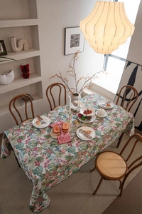 Close-up of bohemian monstera leaf and butterfly jacquard pattern on tablecloth