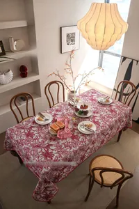 Detail of red and white floral jacquard tablecloth with 3D shell embroidery edges