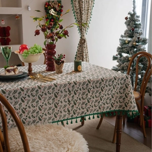 Christmas tablecloth with gold holly leaves and red berry print with green tassels