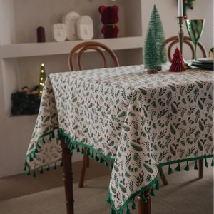 Christmas tablecloth with holly berry print and green tassels for holiday dining table decor