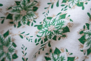 Macro detail of Christmas green and gold holly leaf print on woven fabric window curtain