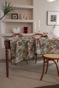 Detailed texture of bohemian floral jacquard tablecloth with green crochet lace edge
