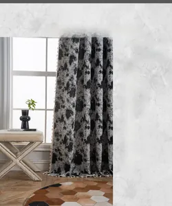Detail of jacquard weave curtain with grey abstract pattern and decorative tassel fringe