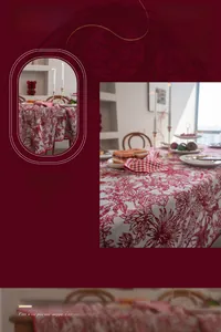 Detail of red jacquard Christmas tablecloth featuring classic Toile de Jouy patterns