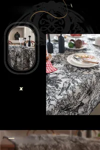Close-up of jacquard floral tablecloth with intricate bird and plant motifs in black and white