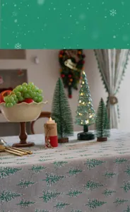 Detailed close-up of green Christmas tree patterns on gray linen fabric tablecloth