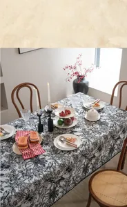 Detailed view of French vintage floral tablecloth with black botanical patterns on white cotton