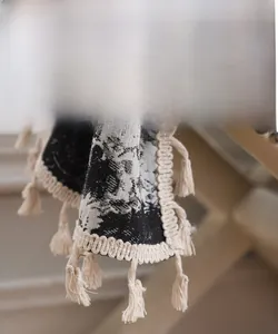 Detailed view of bohemian curtain fabric with vintage floral print and handmade tassels