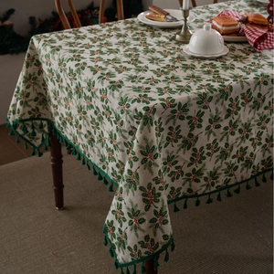 Christmas tablecloth with holly leaves, red berries, and green tassels for festive dining decor