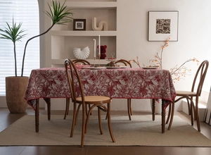 Detail of red and white jacquard tablecloth featuring vintage floral and bird patterns