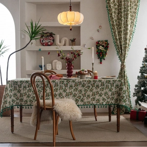 Christmas tablecloth featuring holly leaves and red berries with green tassels