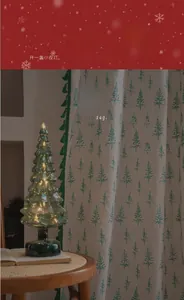 Detail of Christmas tree pattern curtain with green tassels and 50% shading effect