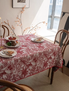Detailed close-up of French Toile de Jouy red floral tablecloth with mini pom-pom lace trim