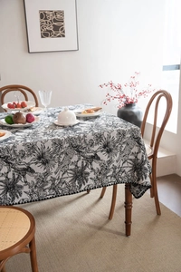 Detail of rectangular black and white jacquard tablecloth with cheetah and floral prints
