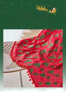 Detail of red Christmas tablecloth with green pine trees, gold foil and red pom pom trim