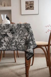 Detailed view of black and white tropical jungle leopard pattern tablecloth with wavy lace edge