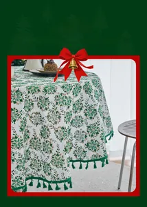 Detailed Christmas tablecloth with green poinsettia patterns, gold foil edges, and fringe