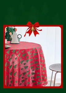 Macro detail of red Christmas tablecloth with pine tree prints and mini pom-pom fringe
