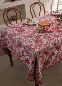 Detail of red and white Toile de Jouy tablecloth with decorative zigzag stitched edges