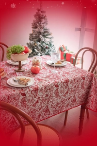Close-up of red and white Christmas tablecloth with floral butterfly embroidery and festive decor
