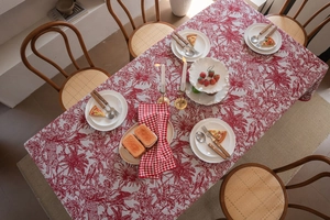Close-up of red and white vintage floral jacquard pattern on a Christmas tablecloth