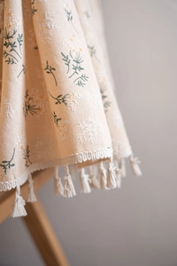 Detail of floral print fabric with handmade tassels for kitchen curtains and home decor