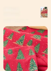 Close-up of red Christmas table runner featuring green trees and gold stamping detail