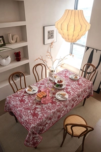 Detailed close-up of red and white Toile de Jouy floral pattern on a rectangular tablecloth