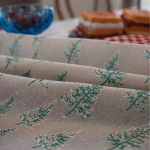 Beige cotton linen Christmas tablecloth featuring green glitter pine tree patterns