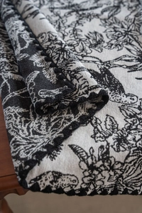 Detailed close-up of American-style black jacquard tablecloth with lace trim