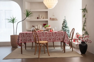 Detailed view of jacquard floral and butterfly embroidery on festive red Christmas tablecloth