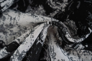 Close-up of black and white floral jacquard fabric with complex woven texture
