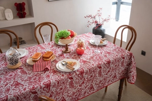 Detail of red butterfly jacquard tablecloth with festive floral and geometric patterns