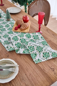 Detailed view of green floral patterns and texture on festive Christmas table runner